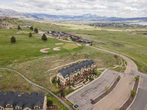 Drone / aerial view of a mountainous background and a golf course