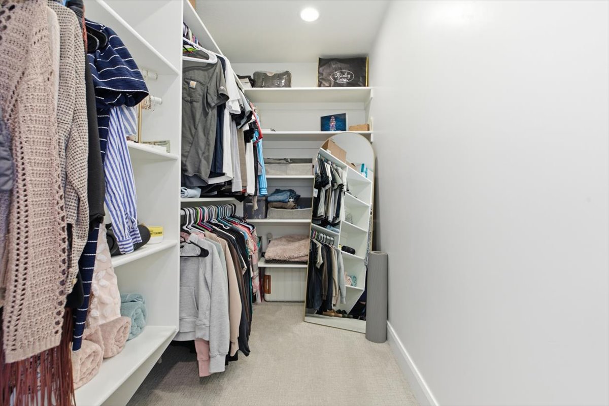 Walk in closet featuring light carpet