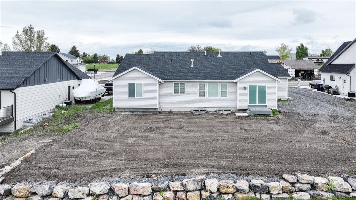 Rear view of property with roof with shingles