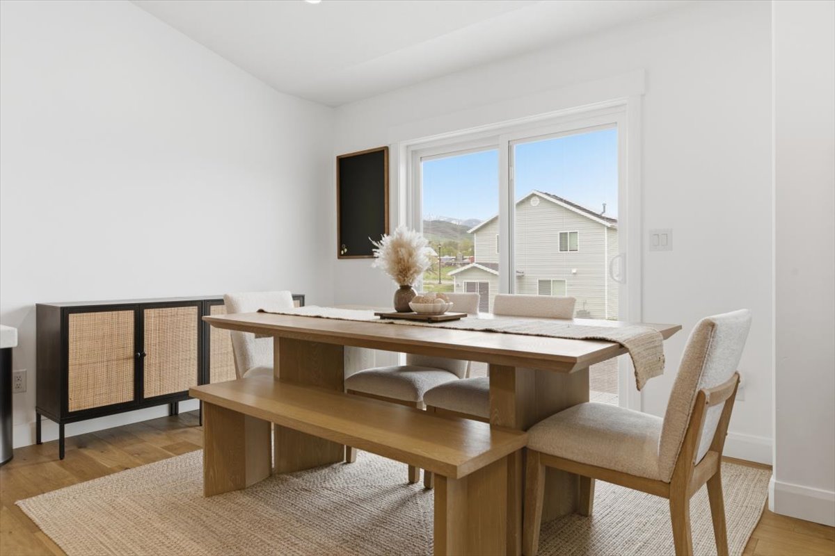 Dining space with light wood-style floors and baseboards