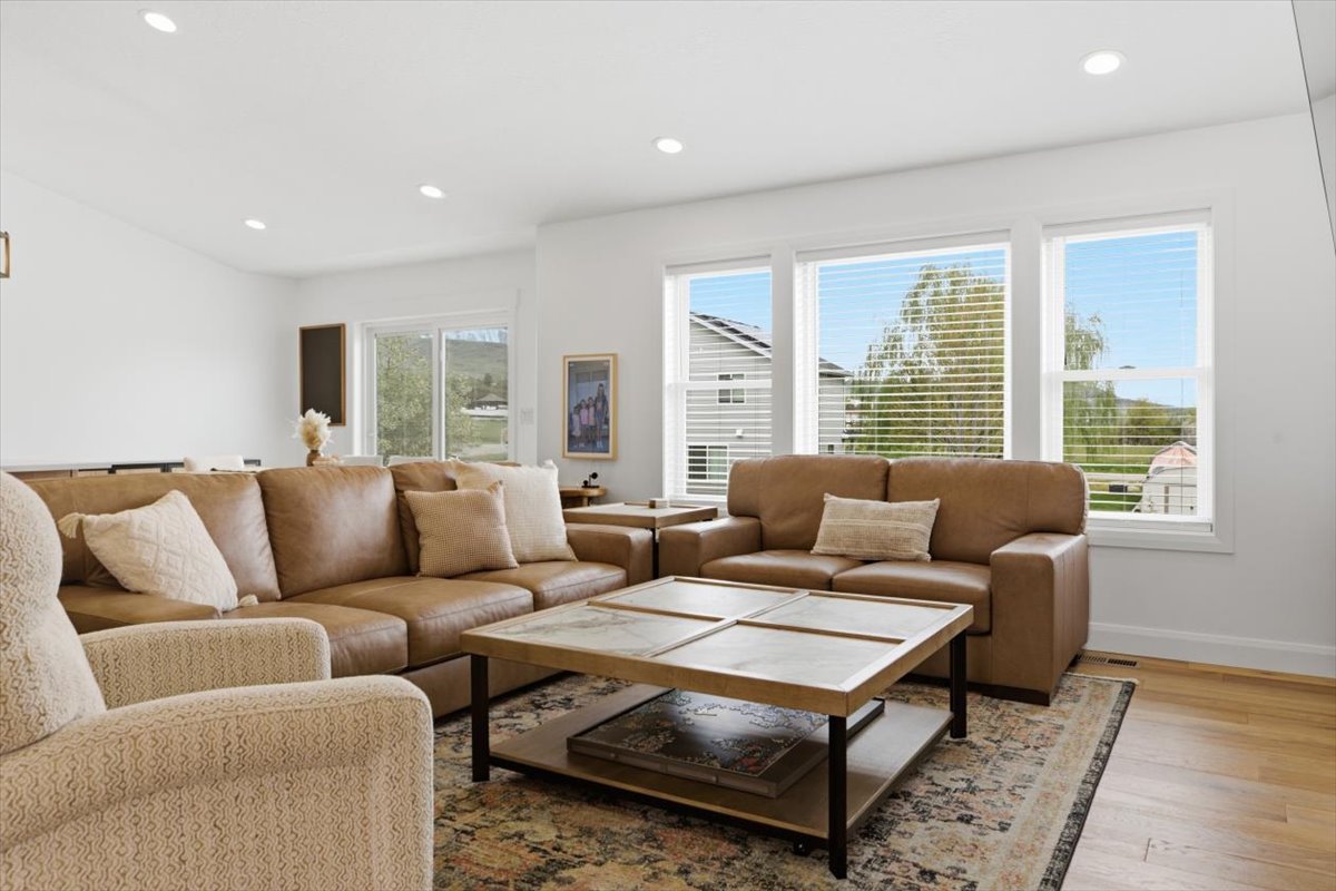 Living area featuring recessed lighting and light wood-style floors