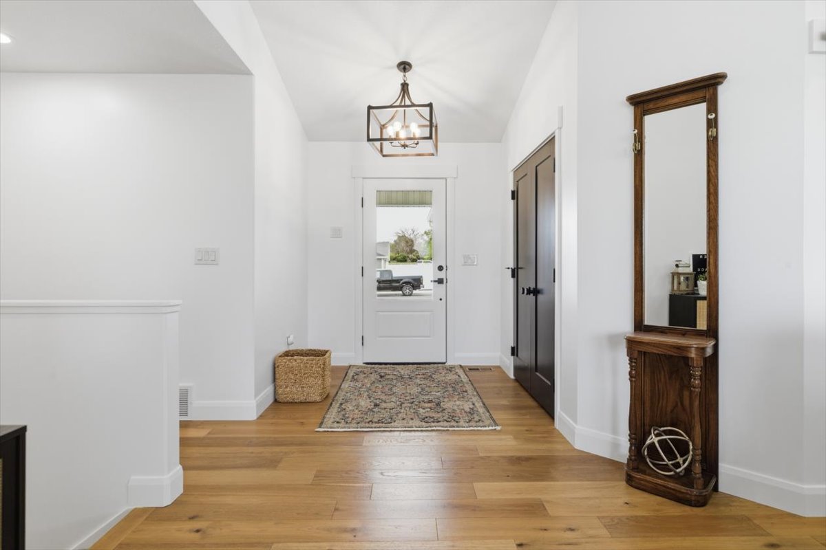 Entryway featuring light wood-style flooring and hanging lights
