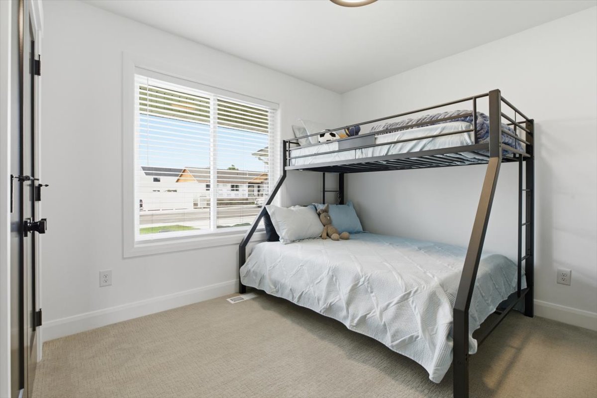 Carpeted bedroom featuring baseboards