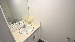 Half bath featuring vanity and toilet