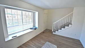 Foyer entrance featuring stairs and dark wood-style floors