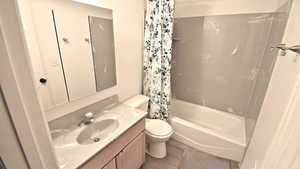 Full bath with vanity and shower / bath combination with curtain