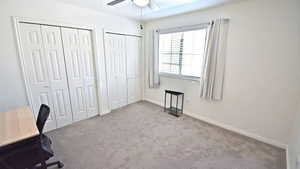 Unfurnished office with carpet and a ceiling fan