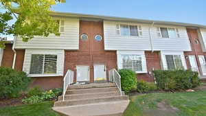 View of front facade featuring brick siding