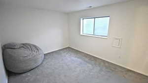 Carpeted empty room featuring baseboards