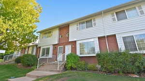 View of front of property featuring brick siding and a front yard