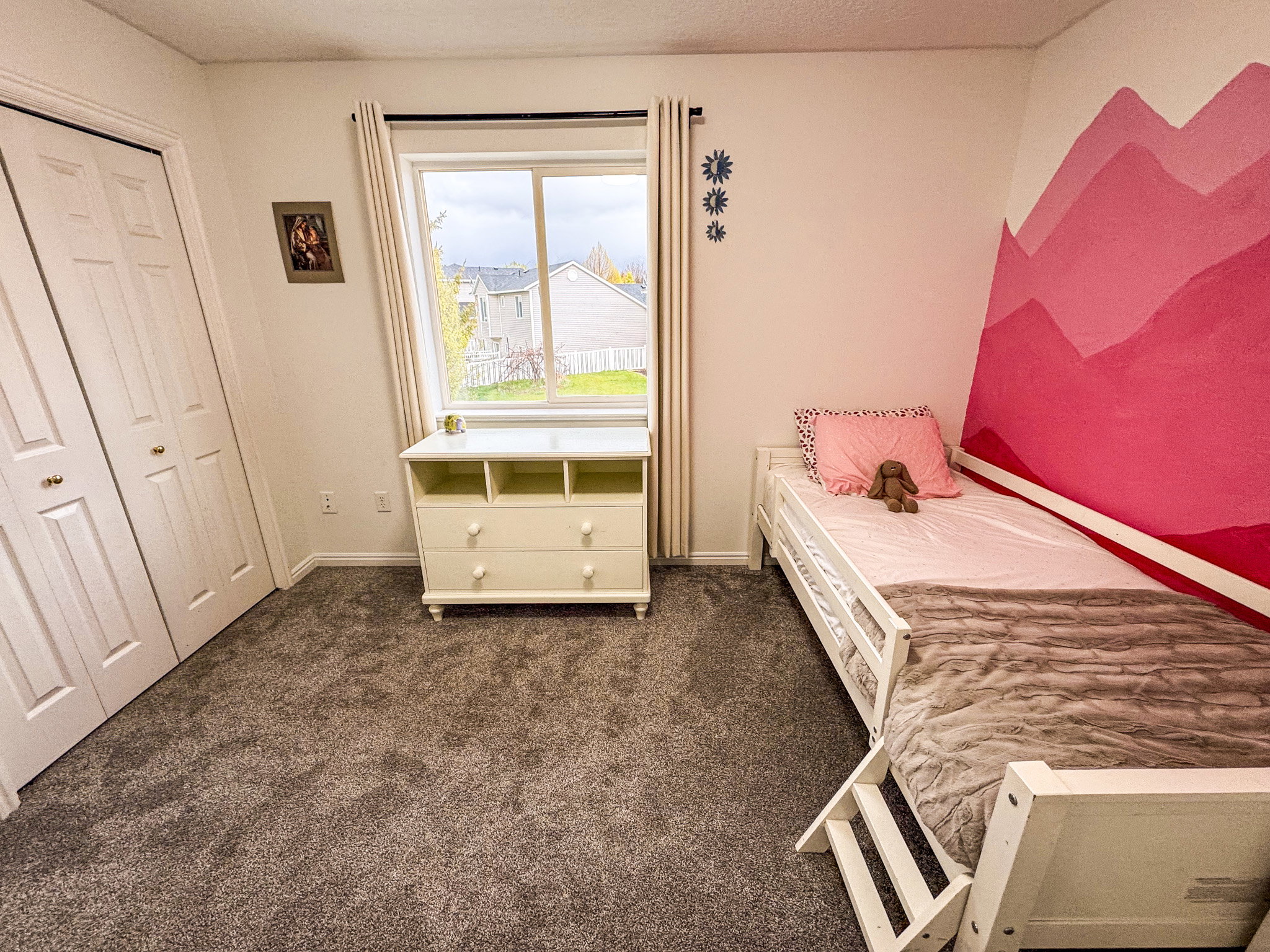 Bedroom with dark colored carpet and a closet