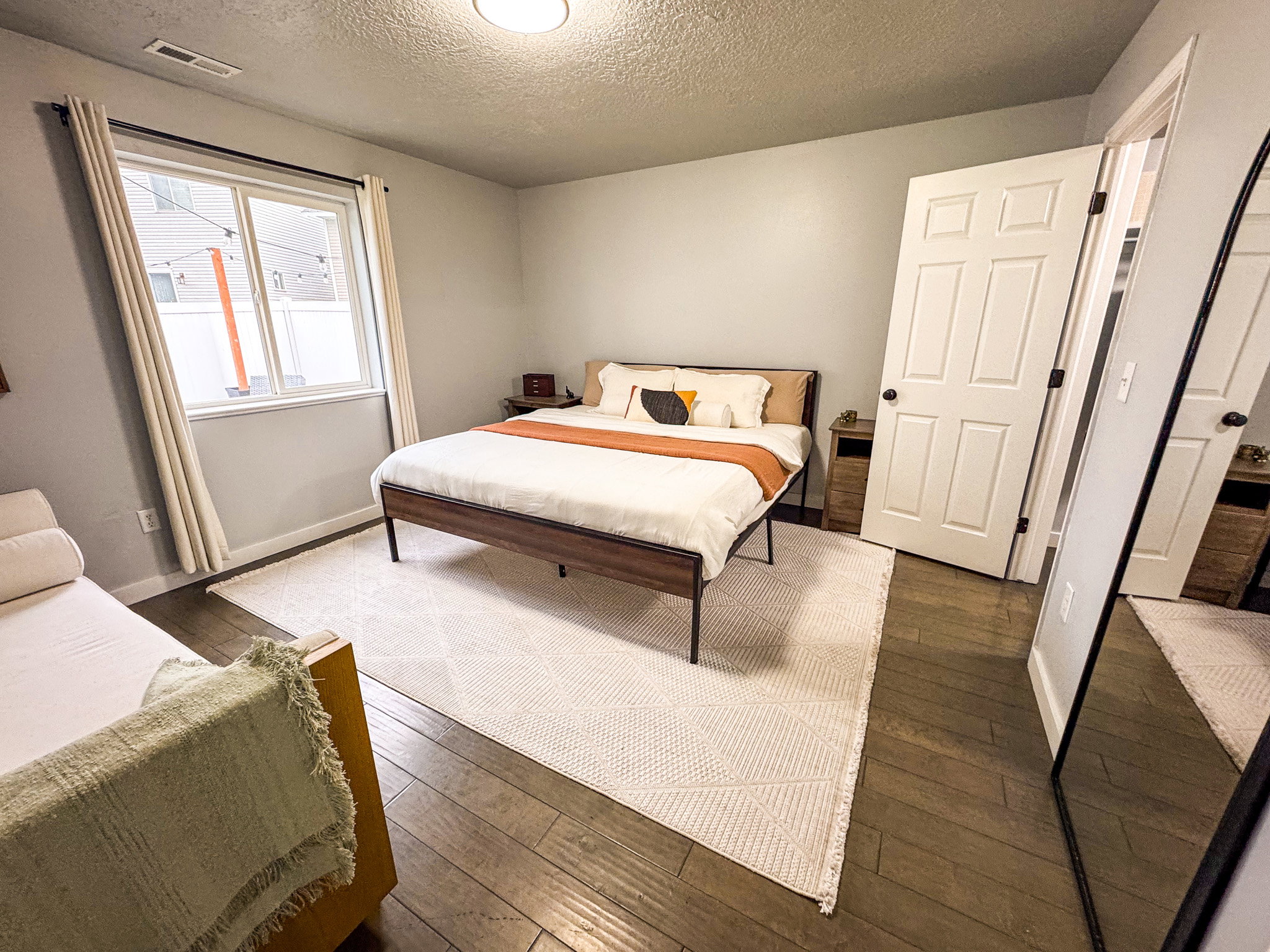 Bedroom with hardwood / wood-style floors and a textured ceiling
