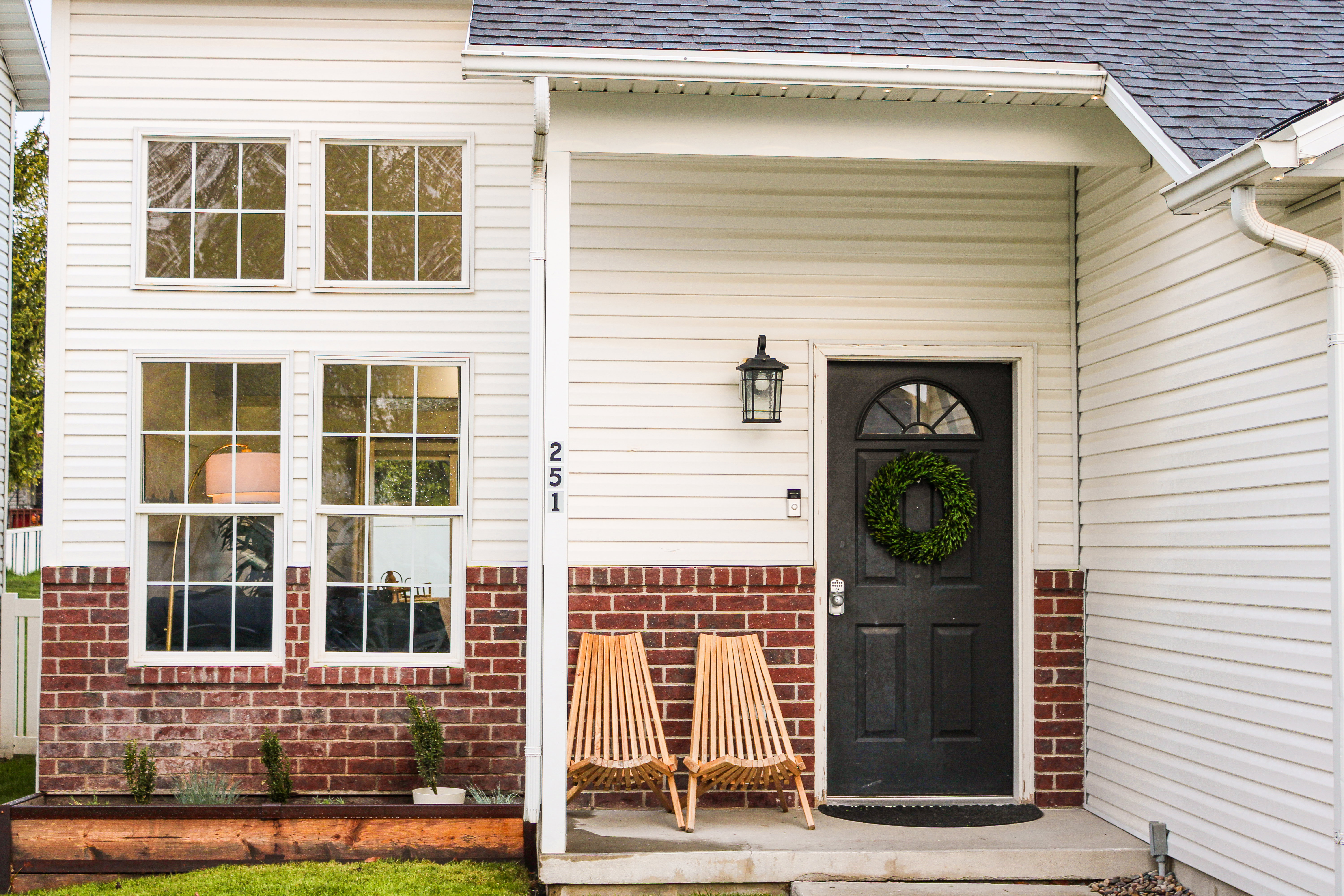 Entrance to property with roof with shingles and brick siding