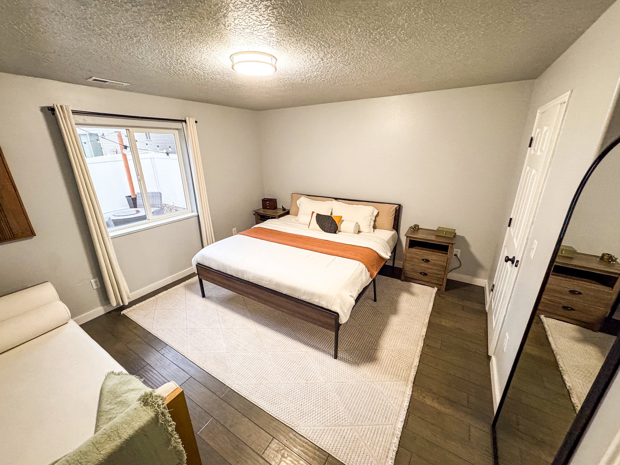 Bedroom with dark wood finished floors and a textured ceiling
