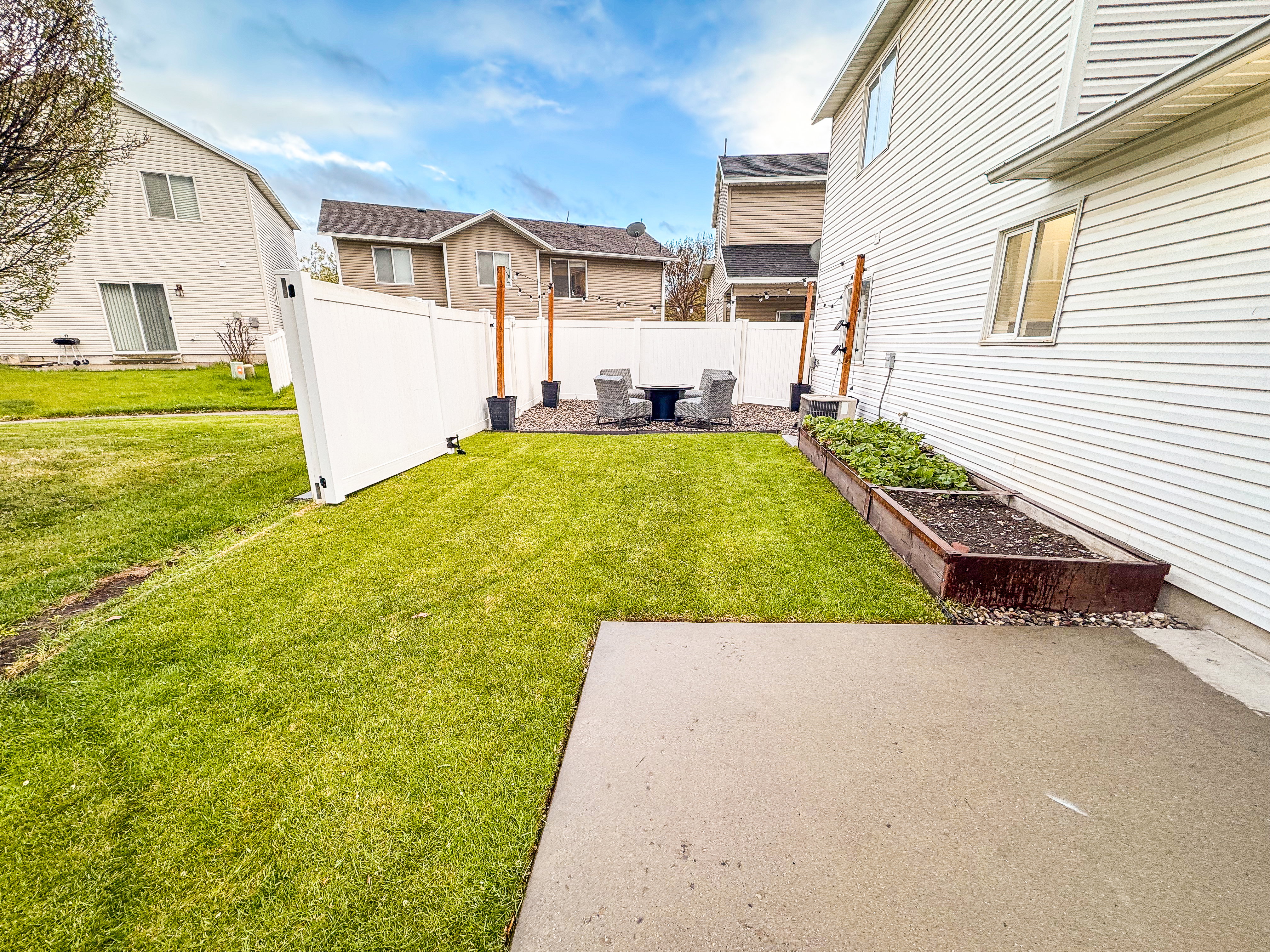 Fenced backyard with a garden