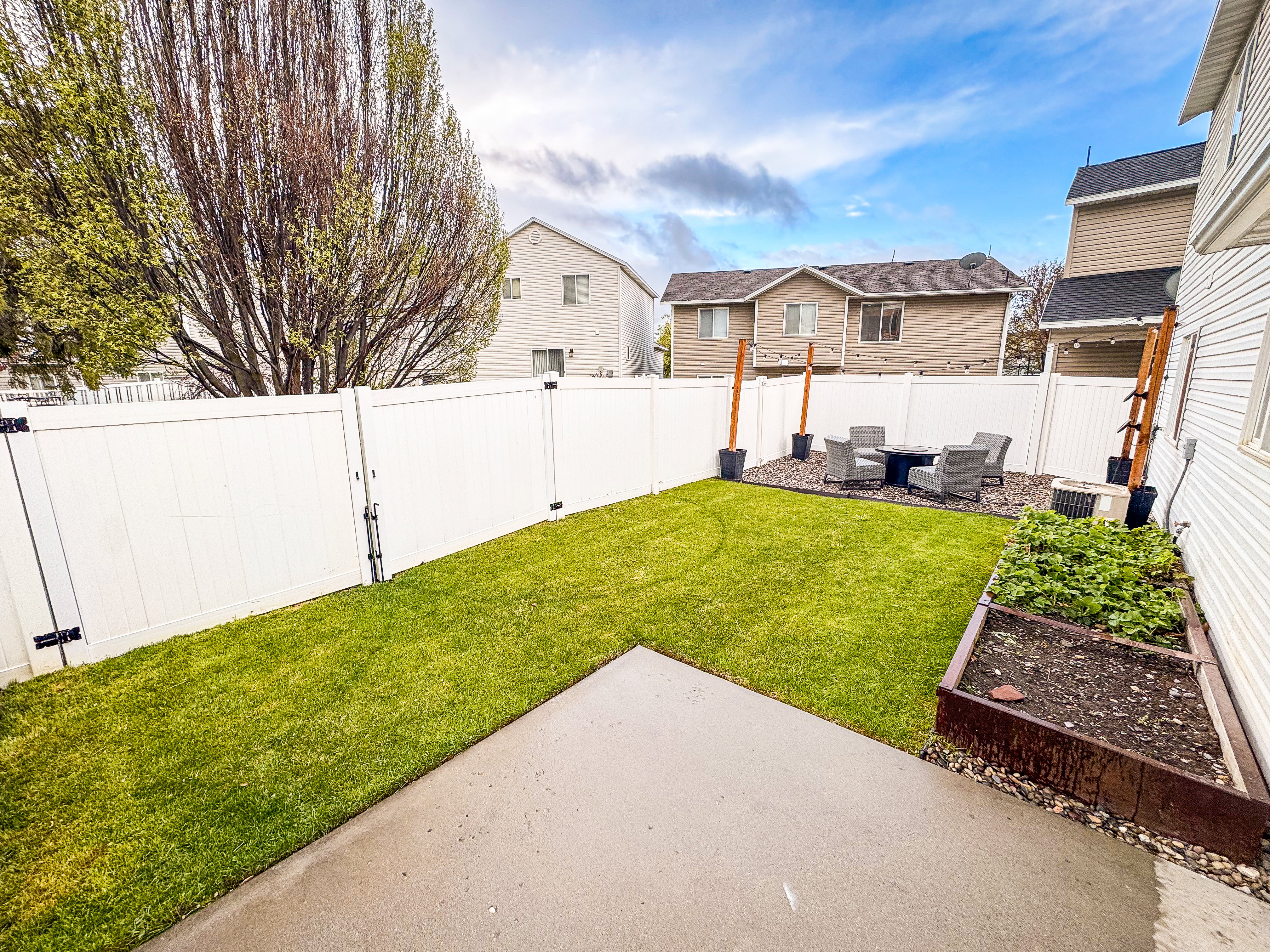 Fenced backyard featuring a residential view and a patio