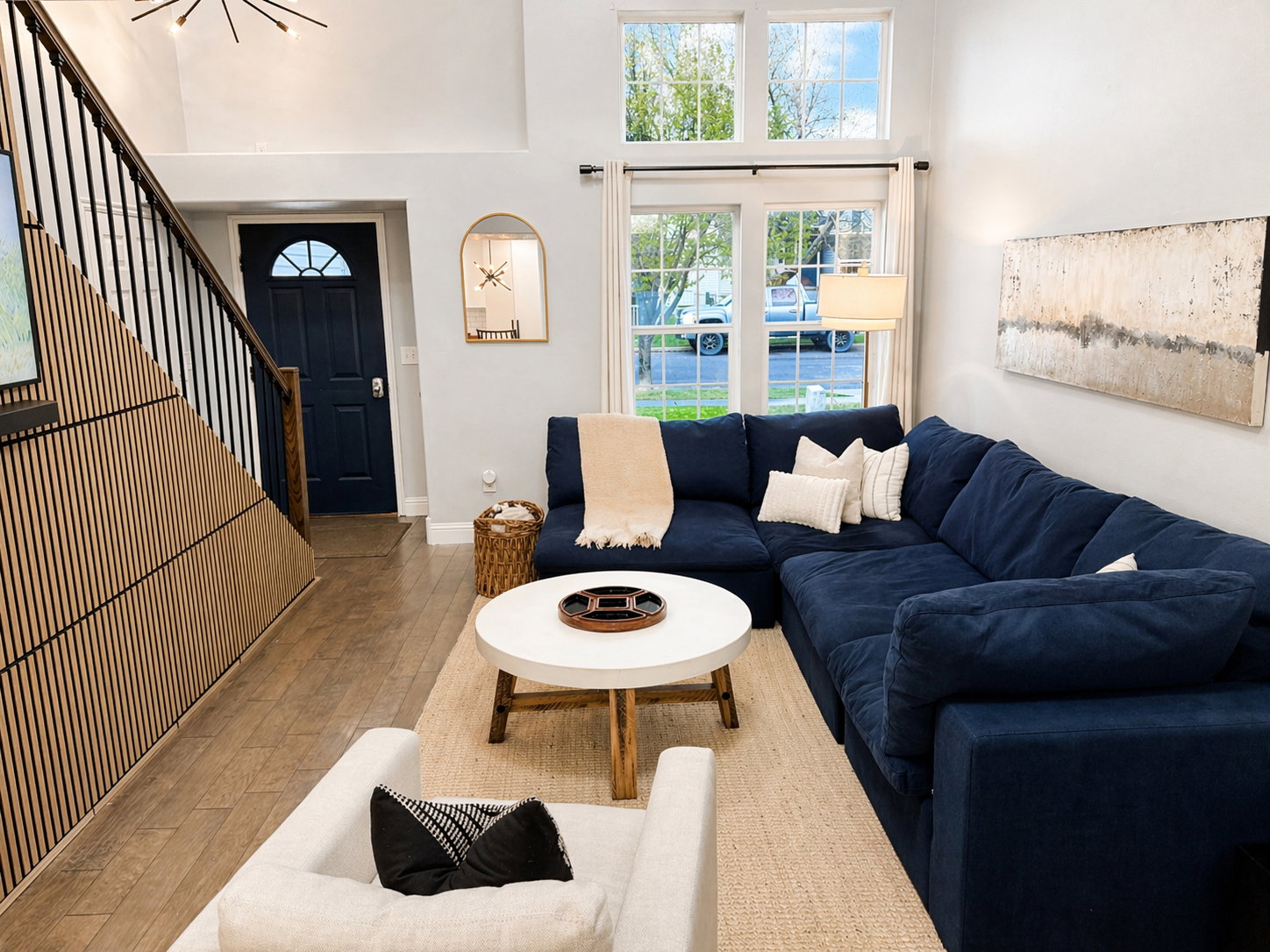 Living room featuring hardwood / wood-style flooring and a high ceiling