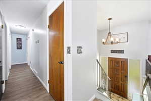 Entryway featuring suspended lighting and wood finished floors