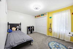 Third upstairs bedroom with light carpet