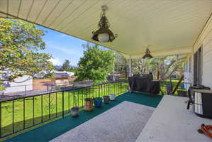 View of covered patio overlooking the backyard