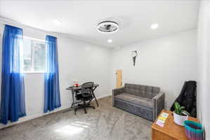 First basement bedroom featuring light colored carpet, ceiling fan, and recessed lighting