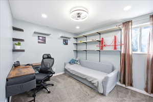 Second basement bedroom with light colored carpet, ceiling fan, and recessed lighting