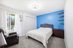 Second upstairs bedroom with light colored carpet