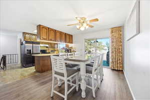 Dining room featuring a ceiling fan and light wood-style floors