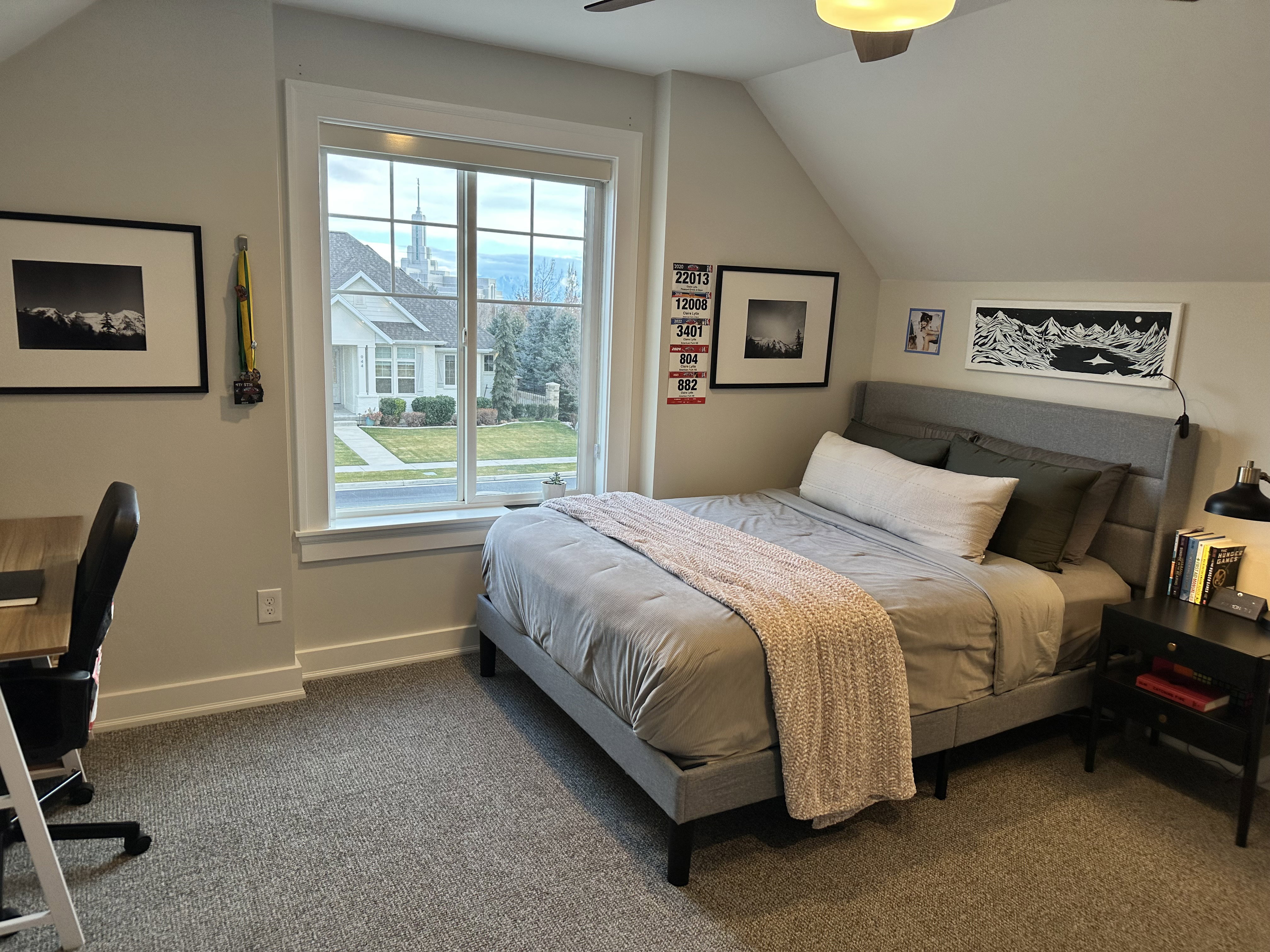 Upstairs Bedroom featuring vaulted ceiling, dark carpet, ceiling fan, and a desk