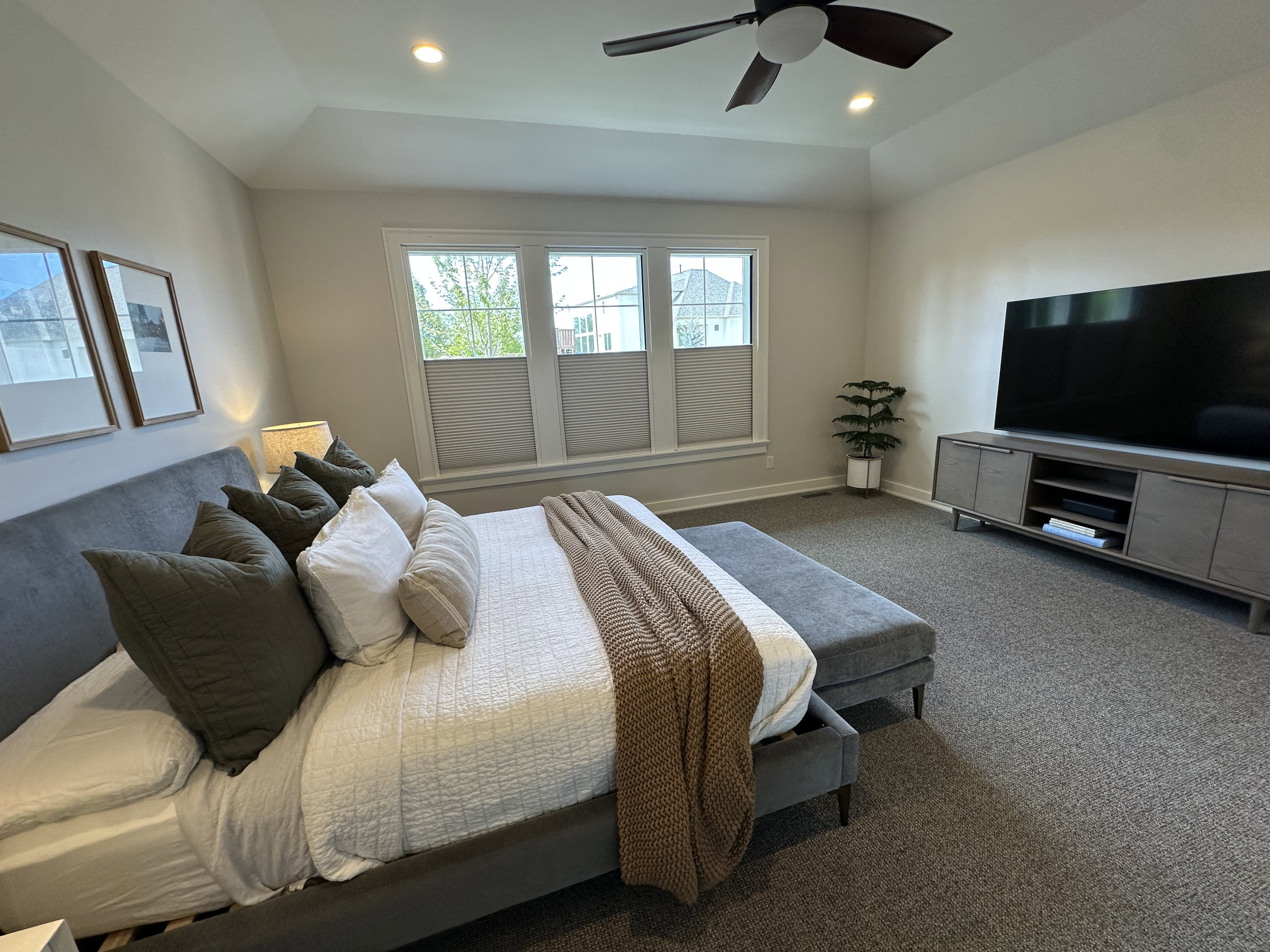 Master Bedroom with dark carpet, ceiling fan, recessed lighting, and lofted ceiling