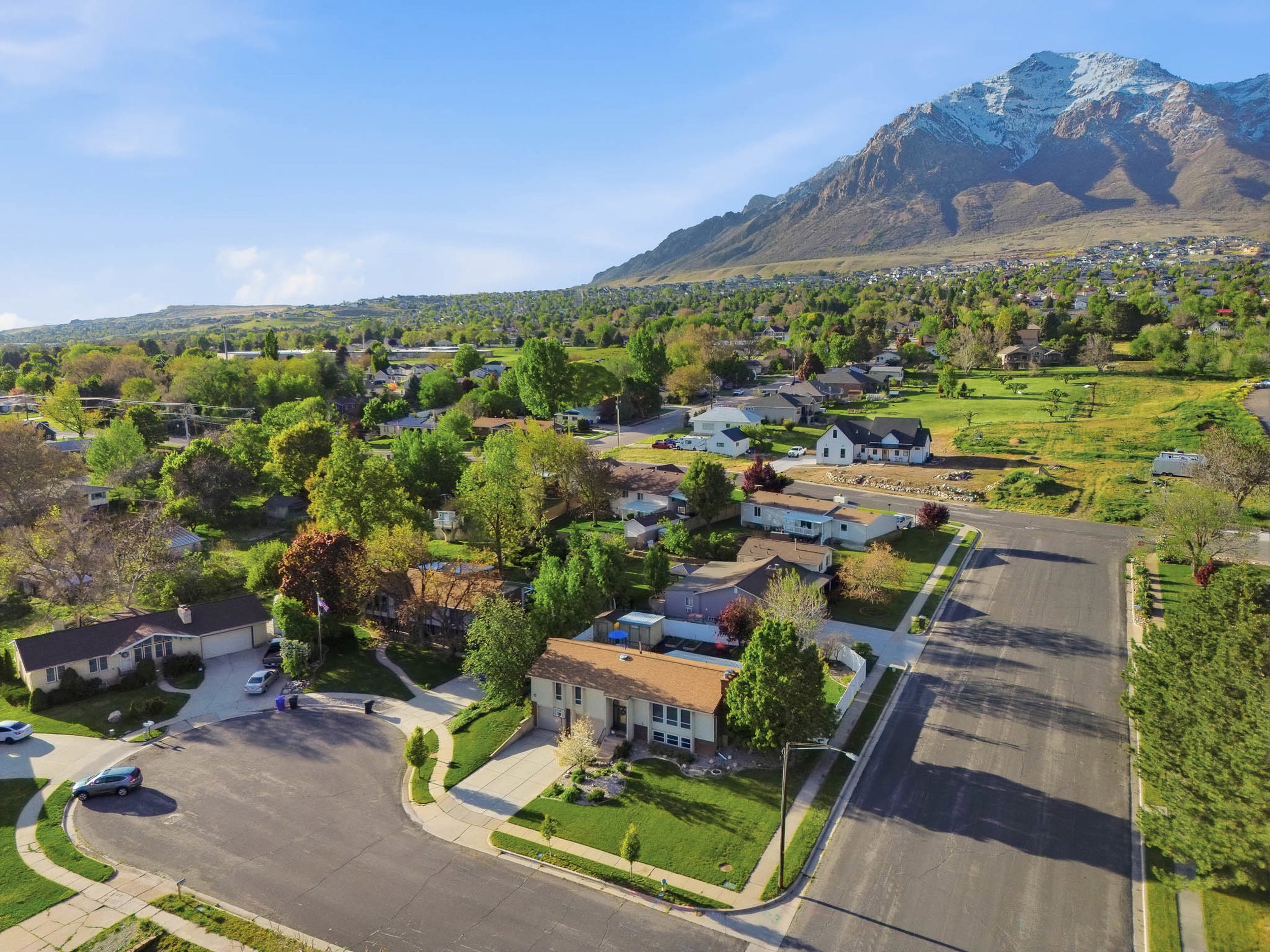 Aerial perspective of suburban area with a mountain backdrop
