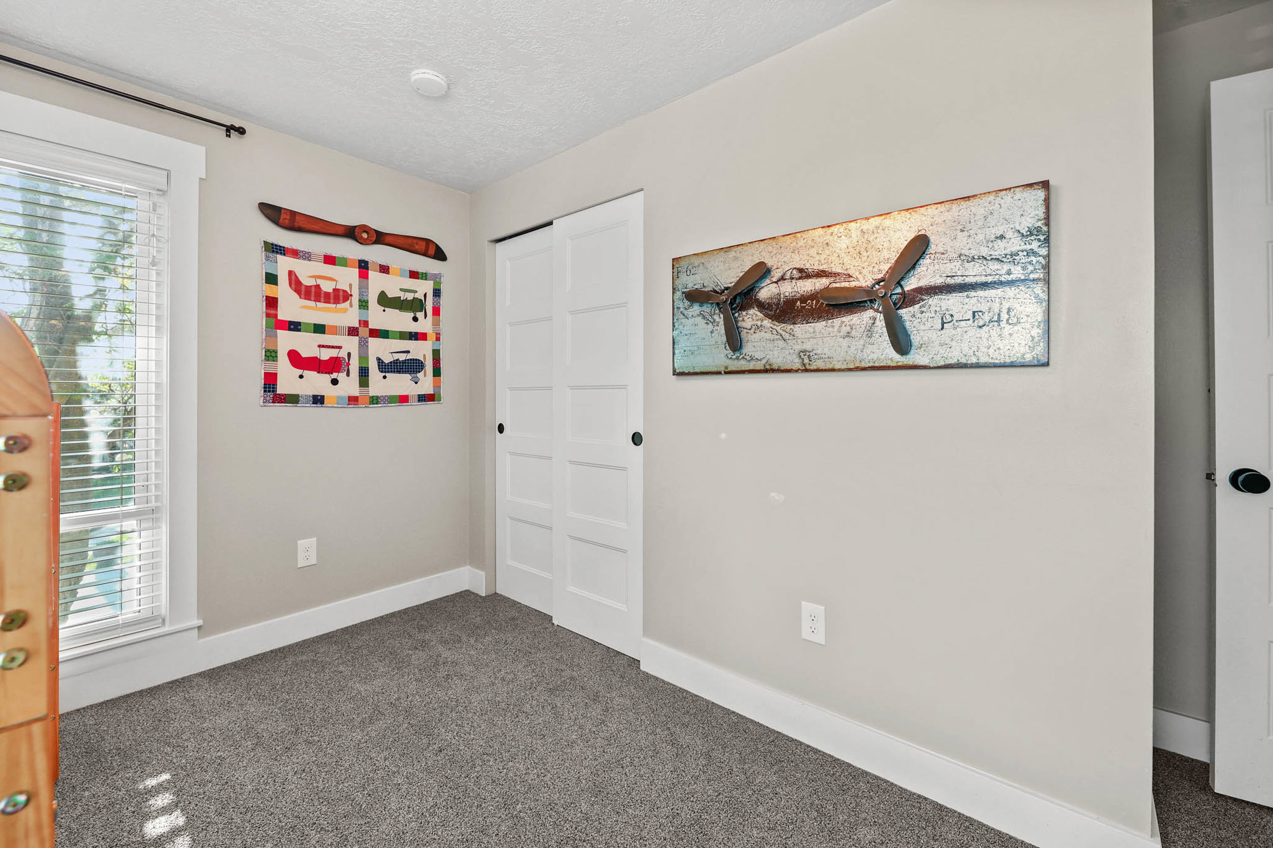Unfurnished bedroom with dark colored carpet, a closet, and a textured ceiling