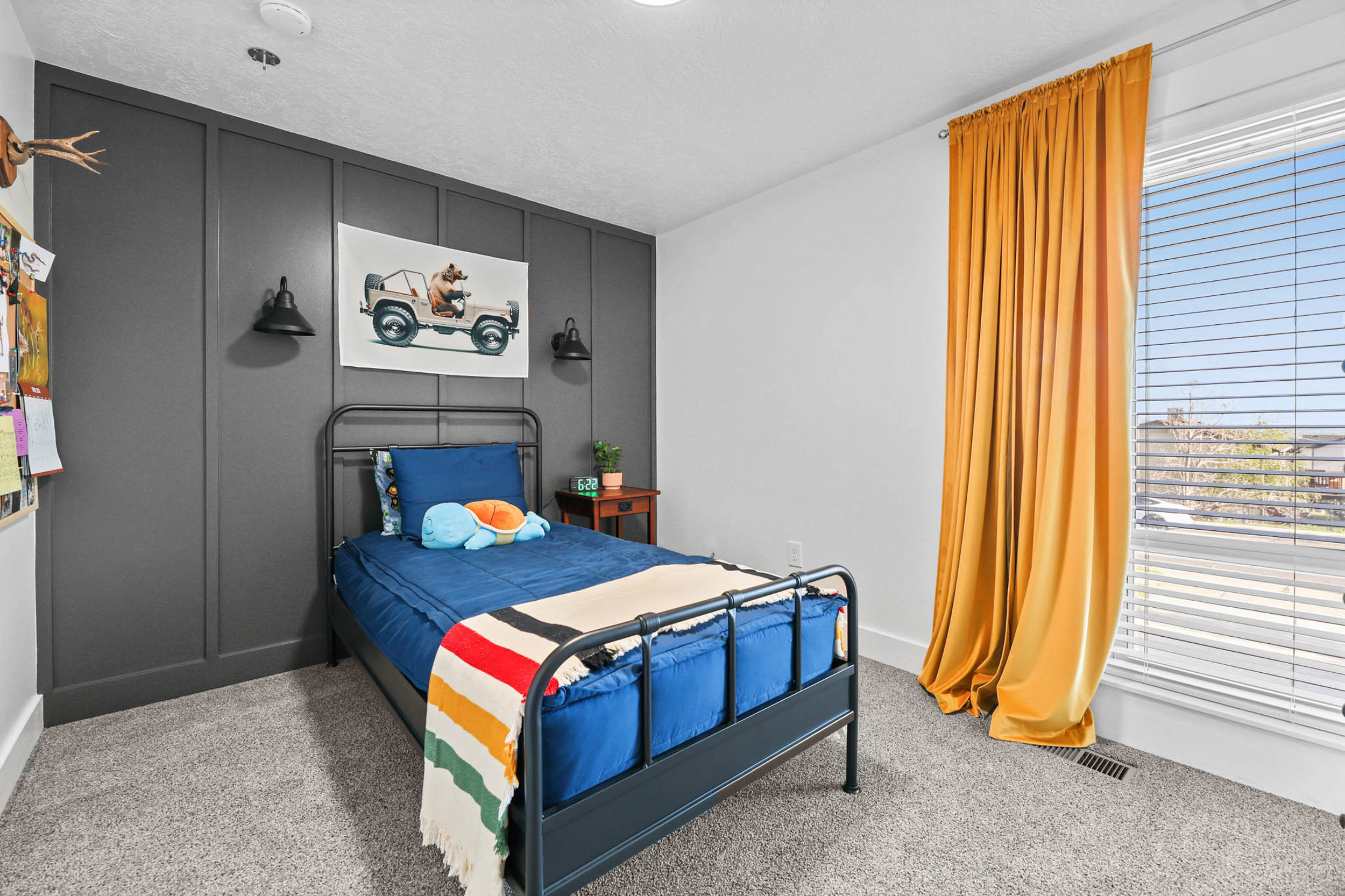 Bedroom featuring a decorative wall and light carpet