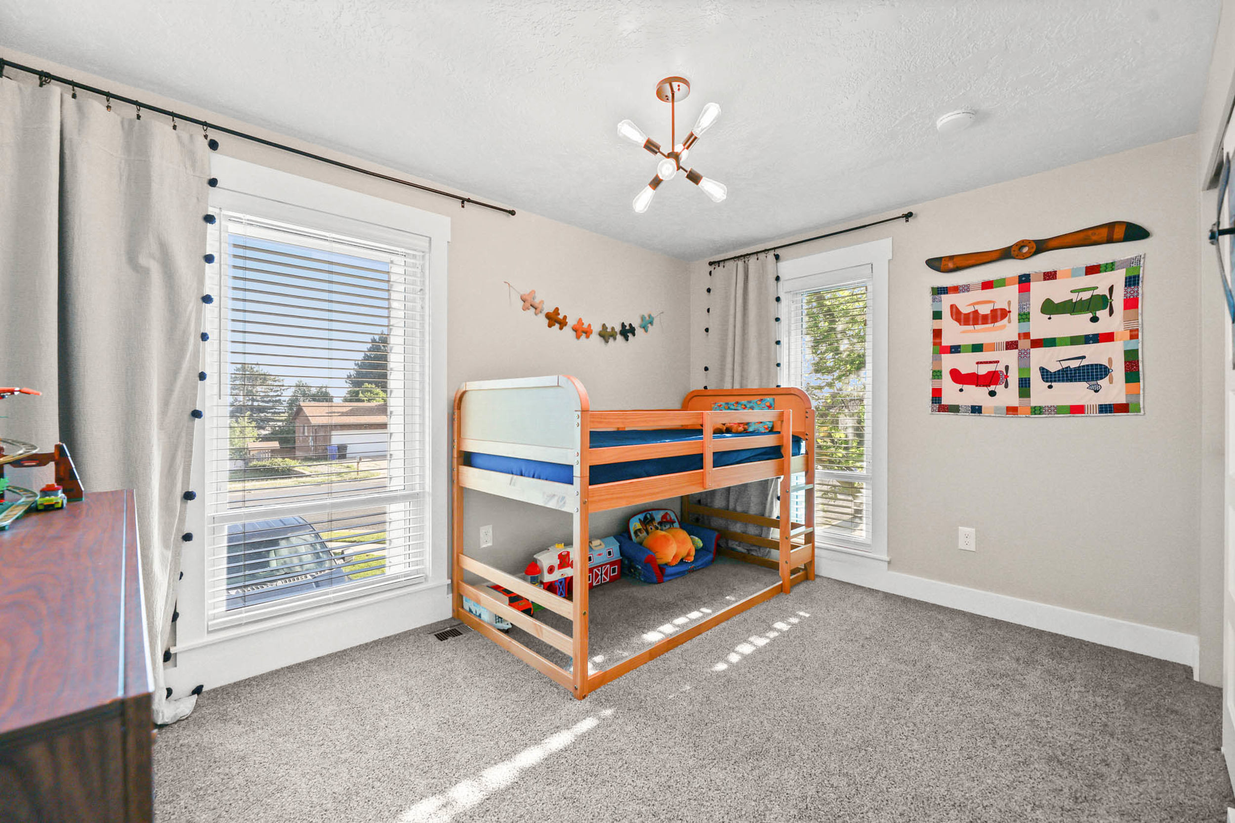 Bedroom with light colored carpet and a textured ceiling