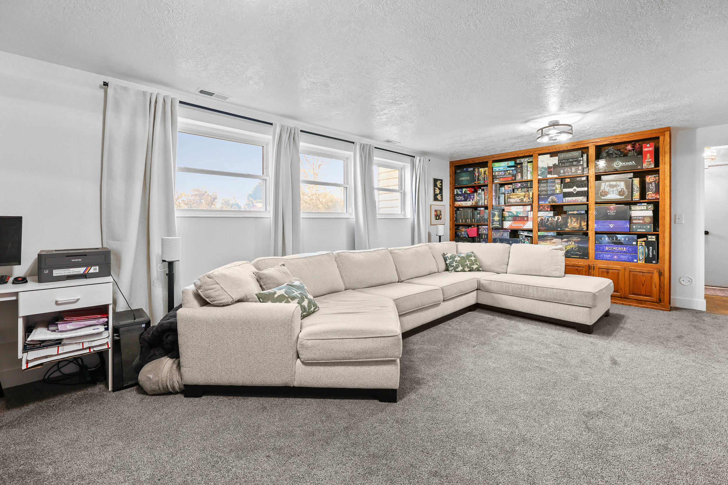 Carpeted living room featuring a textured ceiling