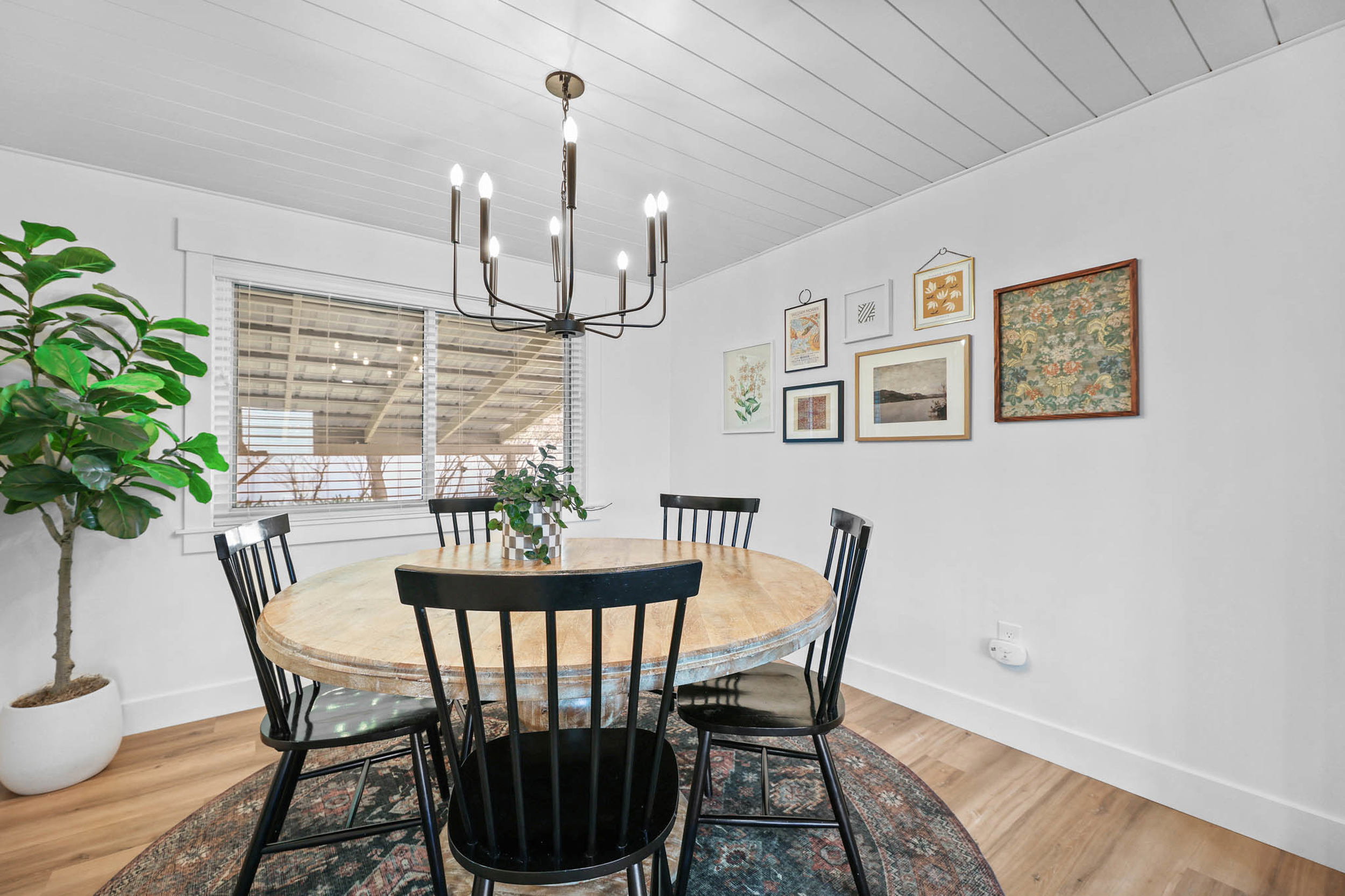 Dining room featuring wood ceiling, light wood-type flooring, and suspended lighting