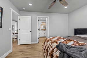 Bedroom featuring light wood finished floors, recessed lighting, ensuite bathroom, and a ceiling fan