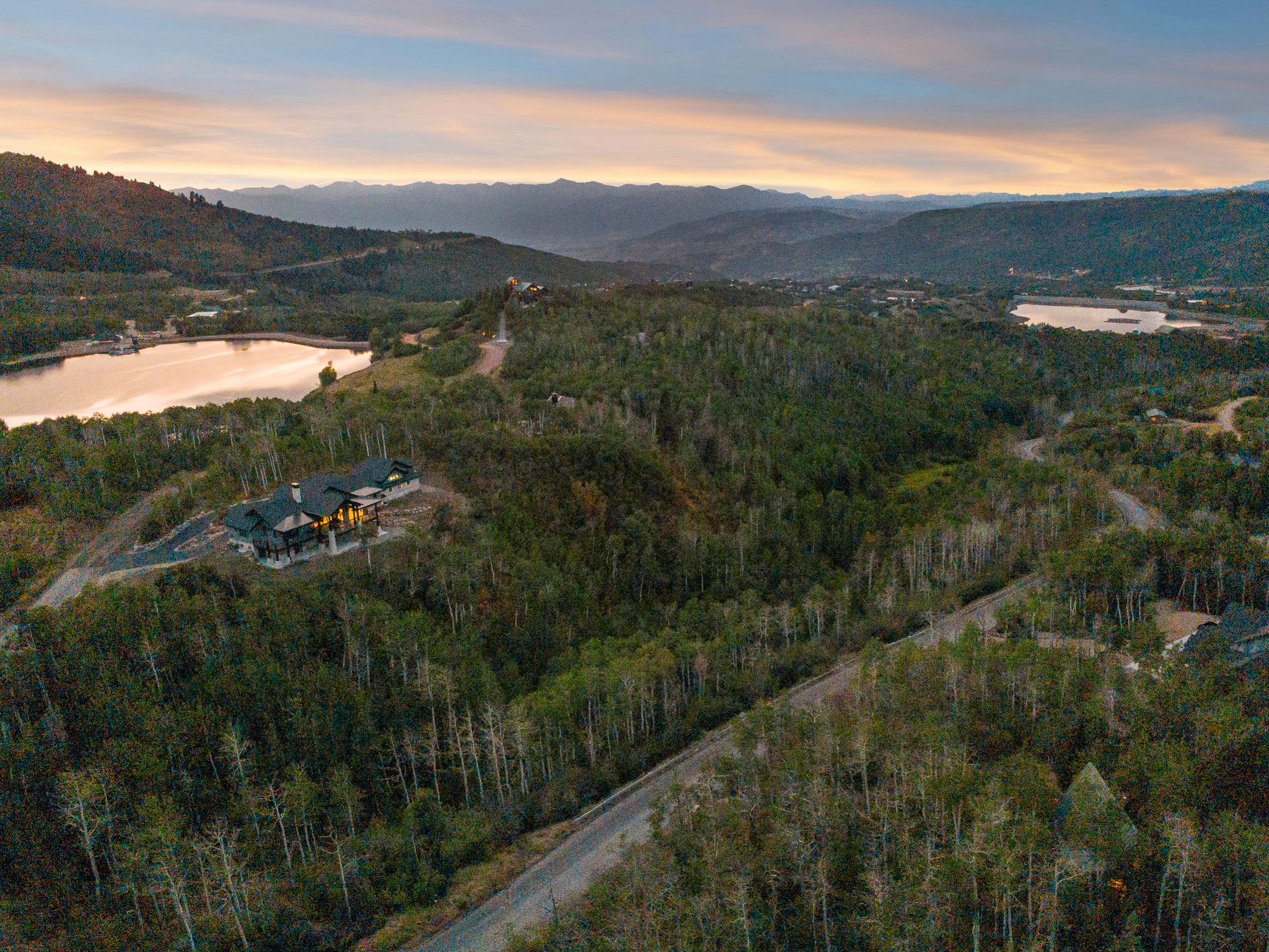 View of property location with a water and mountain view and a forest