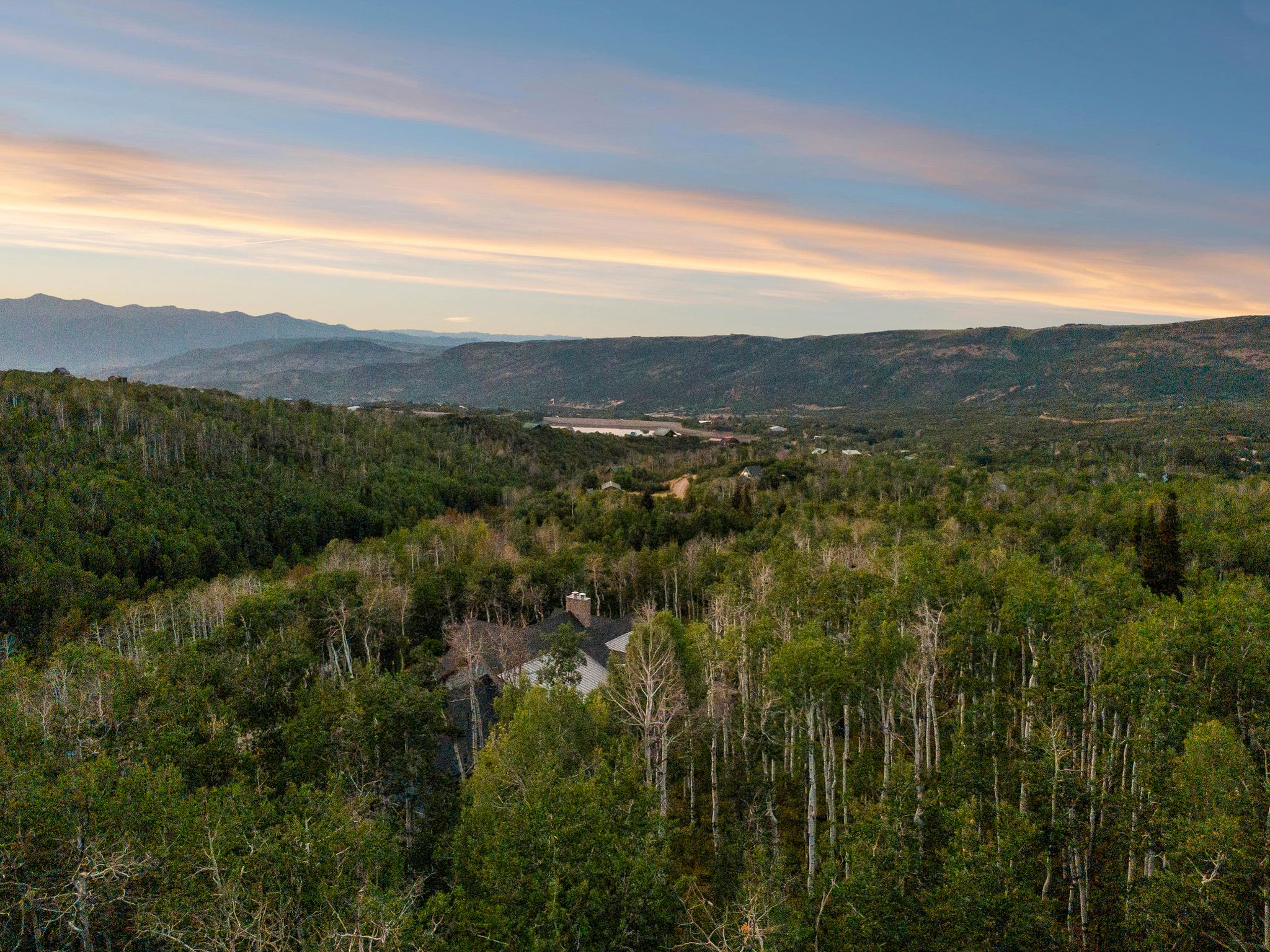 View of mountain backdrop featuring a forest