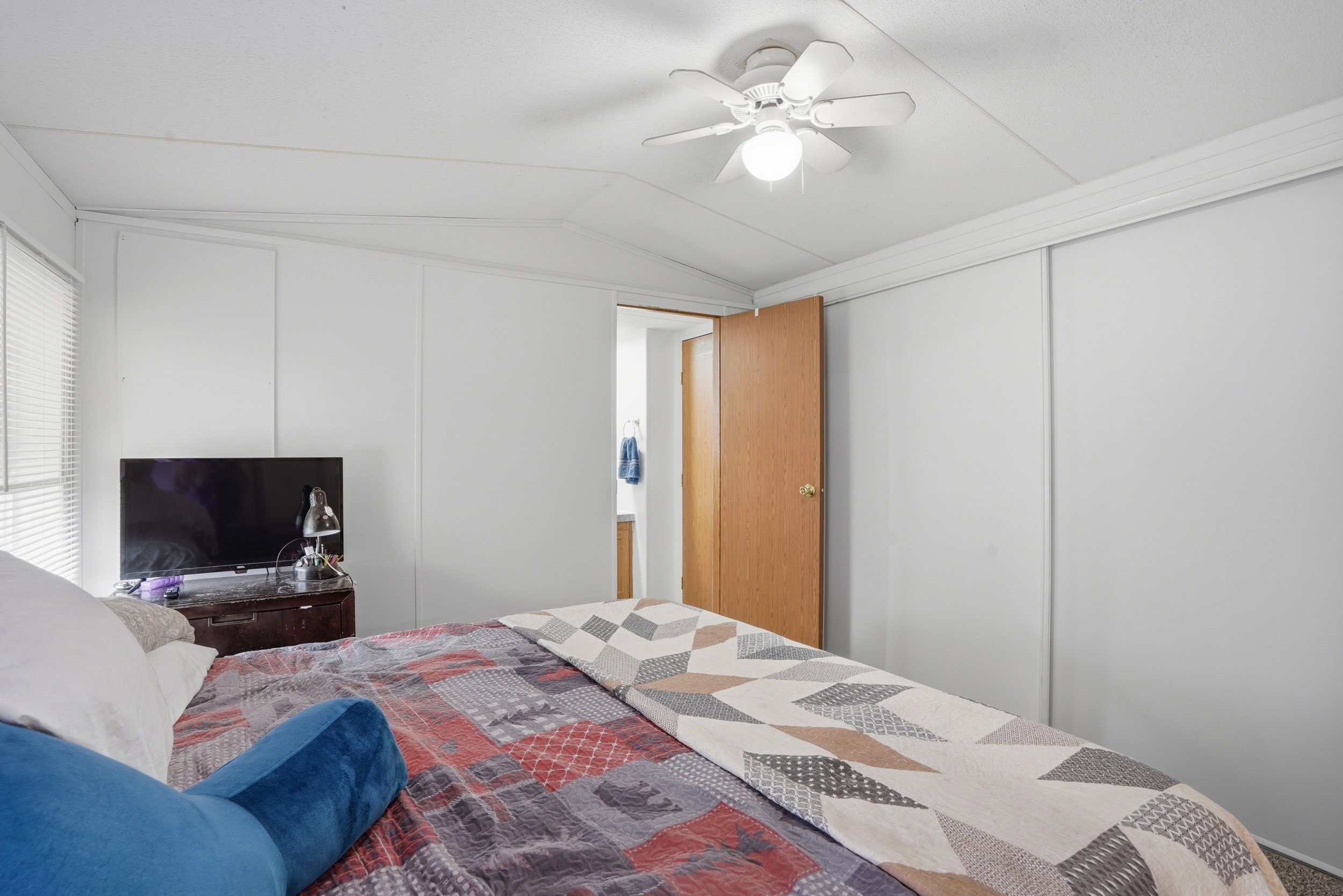 Bedroom featuring lofted ceiling, a ceiling fan, and a closet