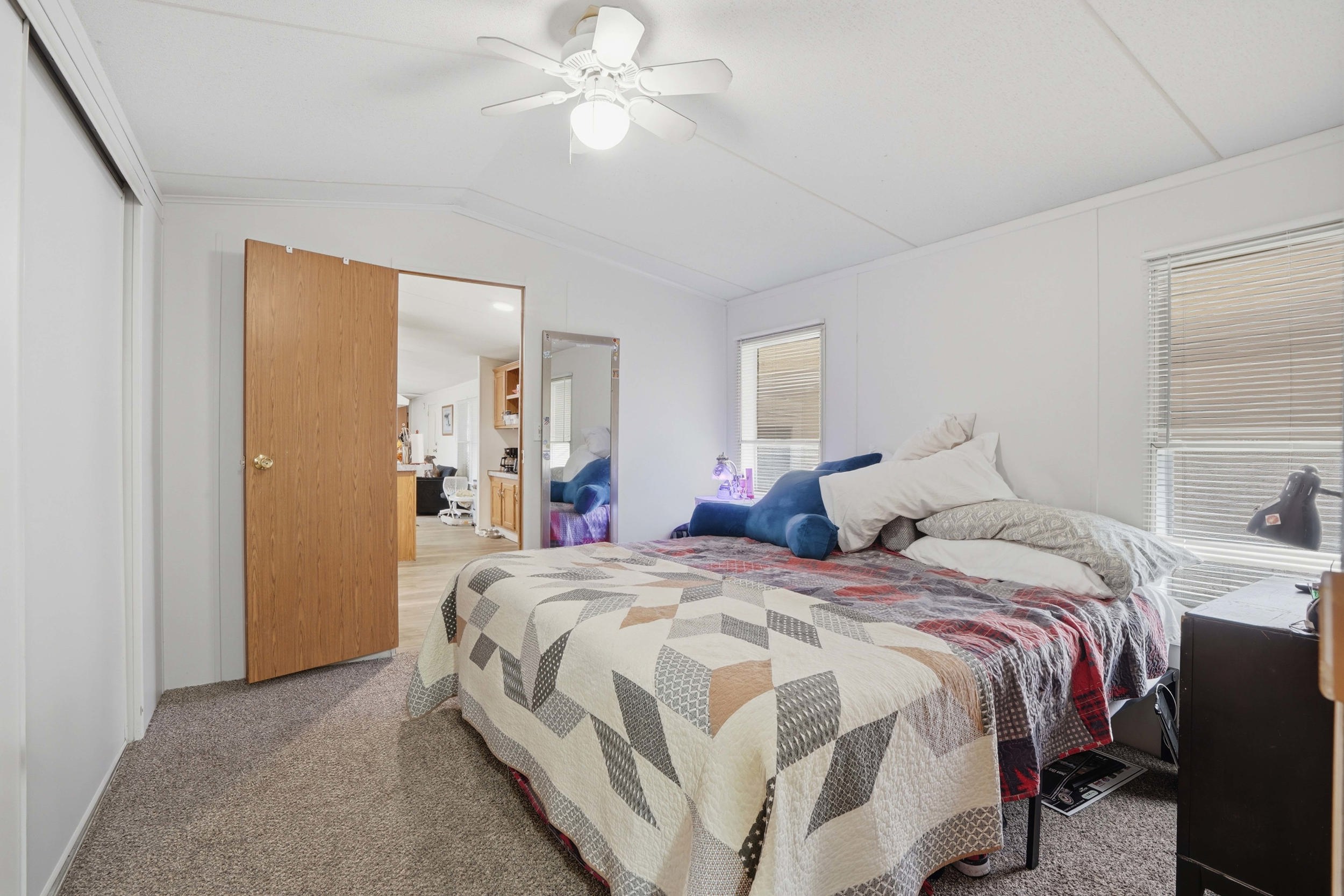 Carpeted bedroom featuring ceiling fan