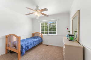 Bedroom with light carpet, ceiling fan, and crown molding