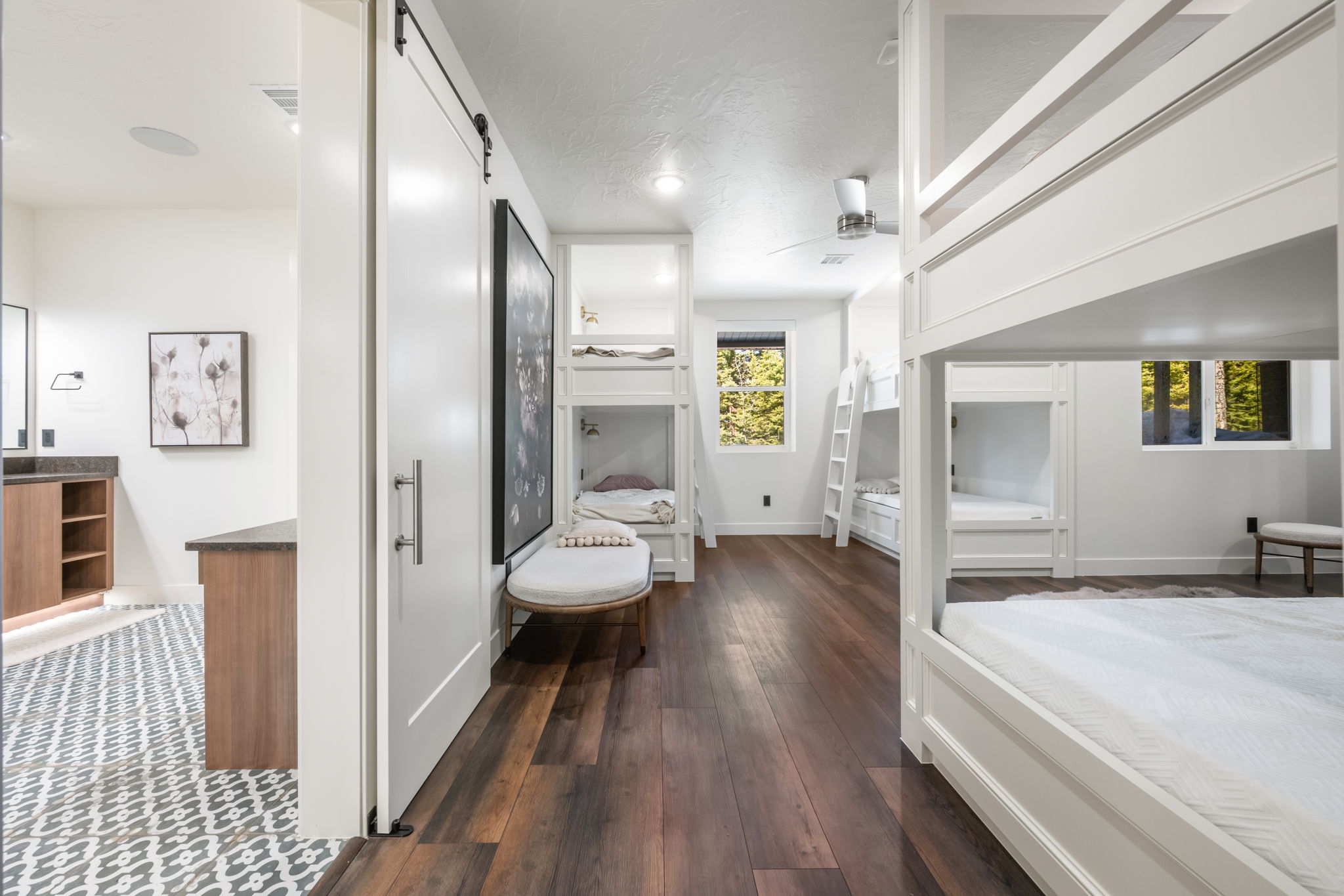 Bedroom featuring dark wood-type flooring and a barn door