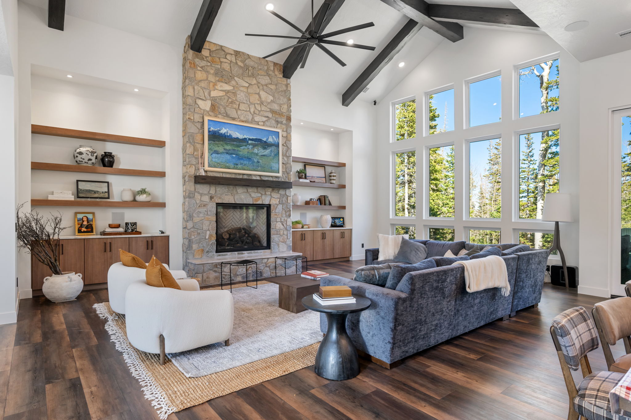 Living room with a fireplace, ceiling fan, dark wood finished floors, recessed lighting, and vaulted ceiling