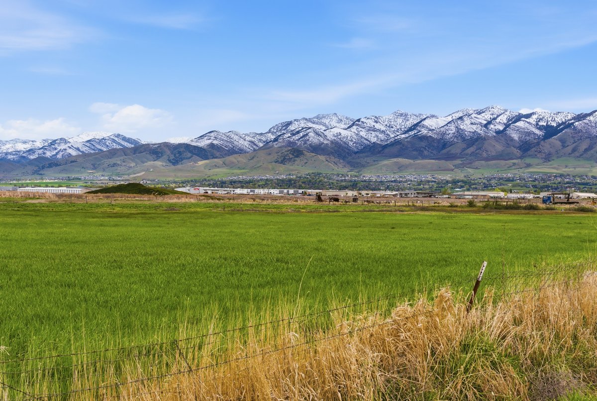 View of mountain backdrop featuring rural landscape and a pastoral area