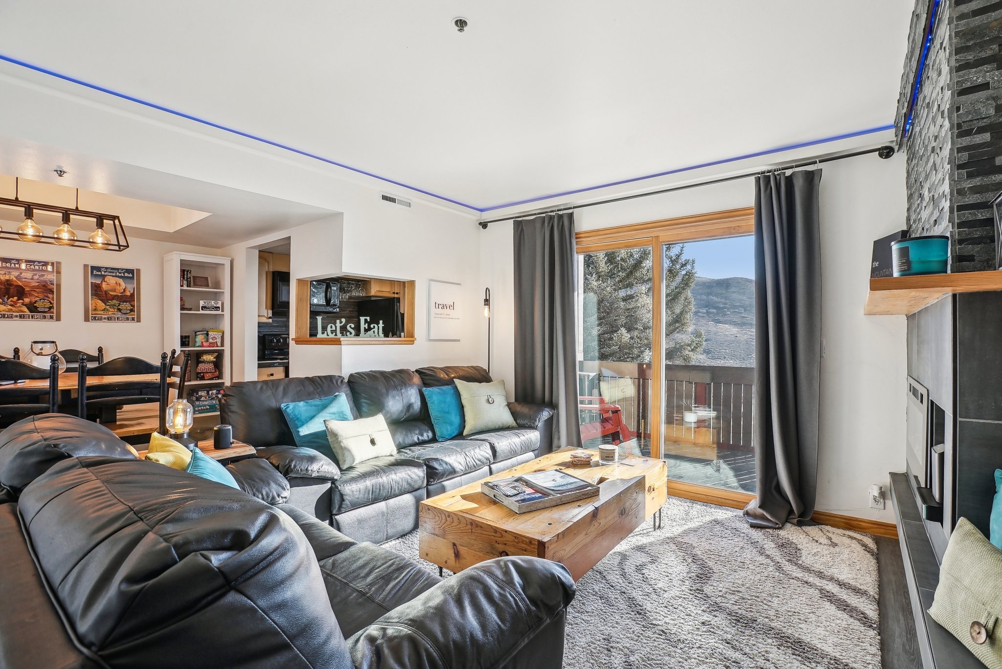 Living area featuring a fireplace and suspended lighting