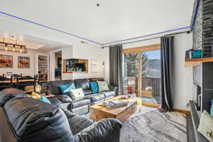Living area featuring a fireplace and suspended lighting