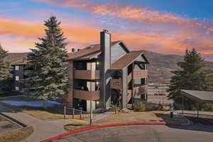Property at dusk featuring a mountain view