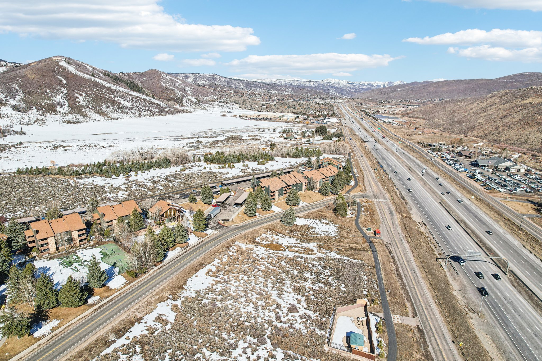 Snowy aerial view featuring a mountain view and a residential view