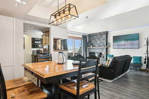 Dining space with light wood-type flooring and a tile fireplace